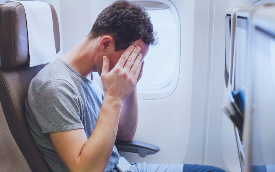 headache in the airplane, man passenger afraid and feeling bad during the flight in plane